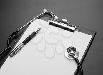 Clipboard, pen and medical stethoscope