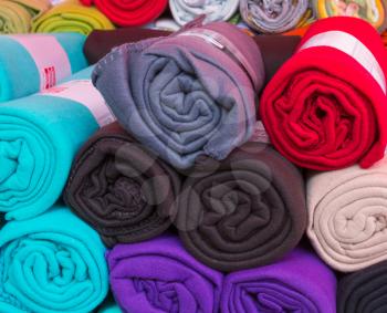 Many rolled colorful fleece blankets