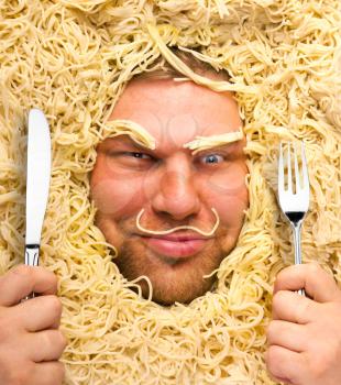 Funny man with fork and knife in pasta