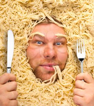 Man's face in pasta, dinner time