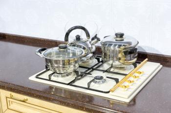 Stove with saucepans on the modern kitchen