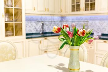 Kitchen interior with kitchen tools and tulip flowers