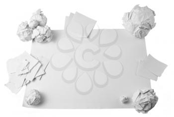 Workspace with crushed paper isolated on white