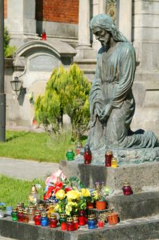 Praying statue and color candles