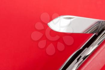 Red Swiss army knife on red background