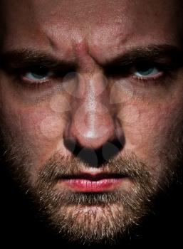 Close-up portrait of angry bearded young man