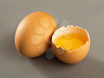 Close-up picture of broken egg isolated on gray background