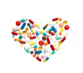 Some different pills in a heart form on white