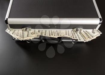 Case with dollars inside isolated on gray background