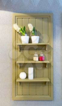 Wooden decorative shelf with flowers and cosmetics on it