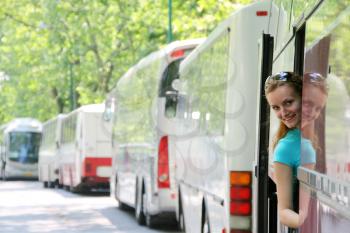 Young smiling tourist girl in bus