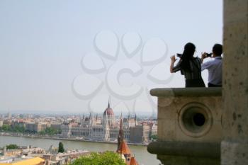 Tourists photographing Budapest Parliament Building