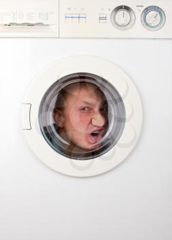 Close-up of bizarre man inside washing machine