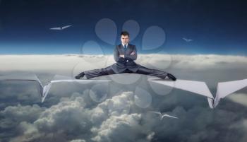 Businessman flying on big paper planes in split