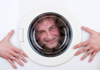Close-up of happy man inside washing machine
