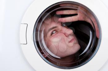 Close-up of bizarre man inside washing machine