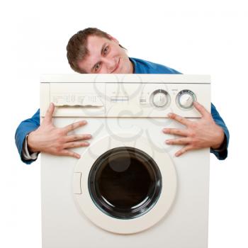 Repairman embraces washing machine. Isolated on white