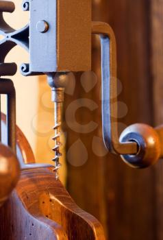 Old wooden corkscrew mechanism in antique interior