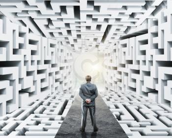 Businessman standing in labyrinth, facing difficulties in business and the stress of daily life