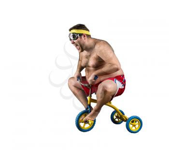 Nerdy adult man riding a small bicycle isolated on white