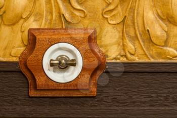 Antique wooden light switch on the wall