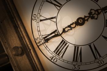 Close-up of antique wall clock. Sepia toned