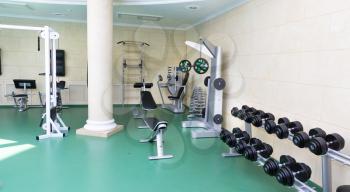 Fitness gym with sport equipment modern interior