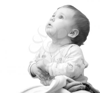 Baby girl with hands clasped together and looking up. Isolated on white