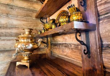 Traditional russian samovar with cups on kitchen