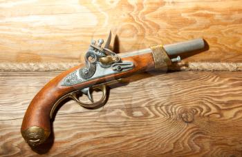 Retro wooden pistol on wood surface