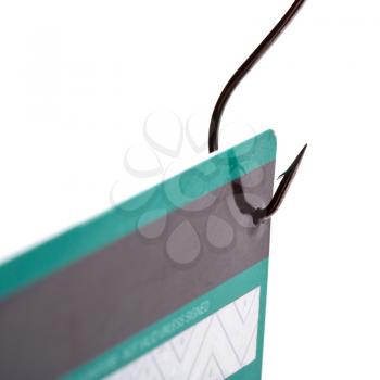 Closeup of a credit card caught on a fishing hook