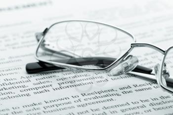 Closeup of glasses on the newspaper
