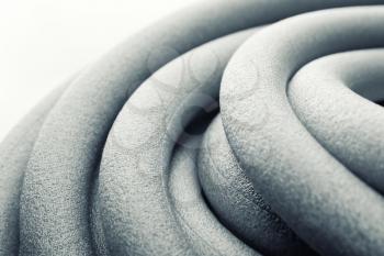 Macro of rolls of thermal insulation foam pipes