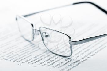 Macro view of glasses on the newspaper