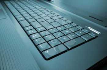 Close-up of modern laptop keyboard. Toned