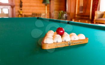 Green luxurious billiard table with balls in order