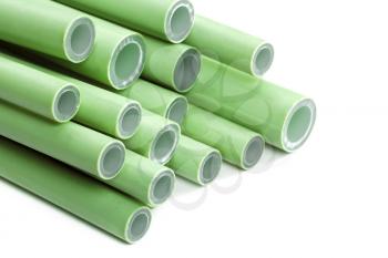 Pile of green plastic pipes on white