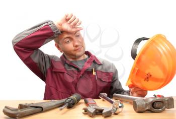Tired working man with tools. Isolated on white