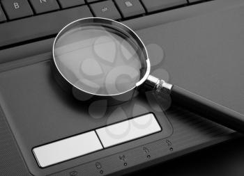 Magnifying glass on laptop computer