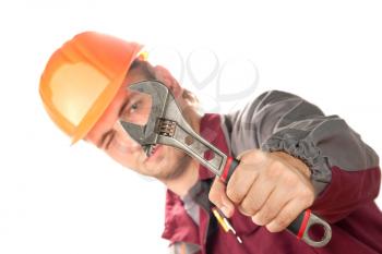 Working man with adjustable wrench. Isolated on white