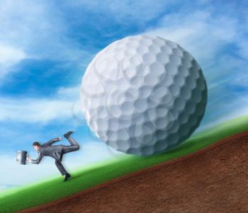 Businessman runs from a big golf ball