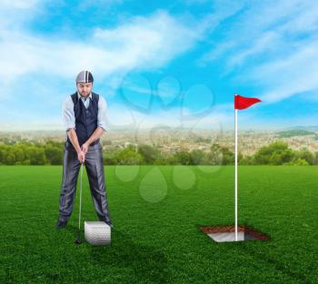 Businessman playing golf with a square ball in open air