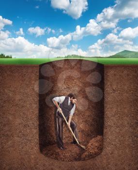 Businessman digs a tunnel deep into the ground