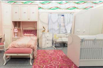 Baby's bedroom in pastel white and pink colors