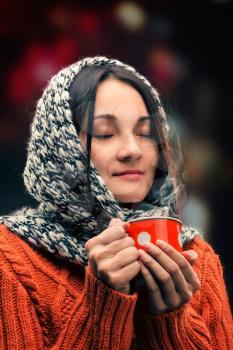Attractive young lady drinking hot tea