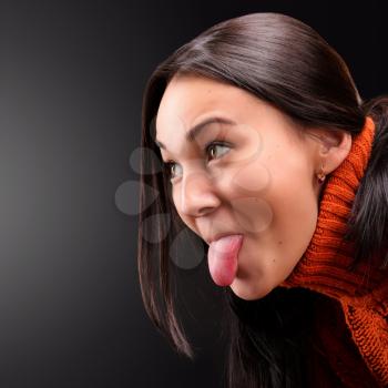Young girl fooling around and showing tongue