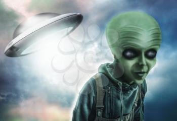 Alien and UFO over dark background