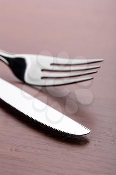 Top view of  fork and knife on wooden table