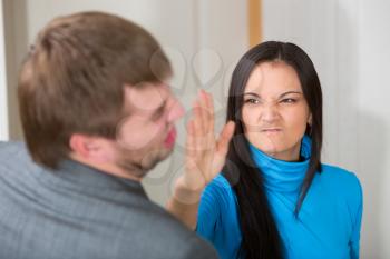 Woman about to slap her partner in living room