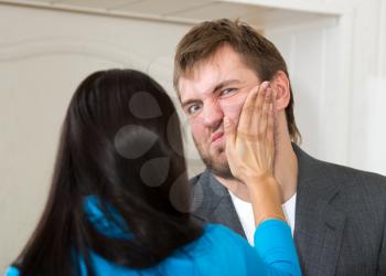 Upset woman slap her partner in living room